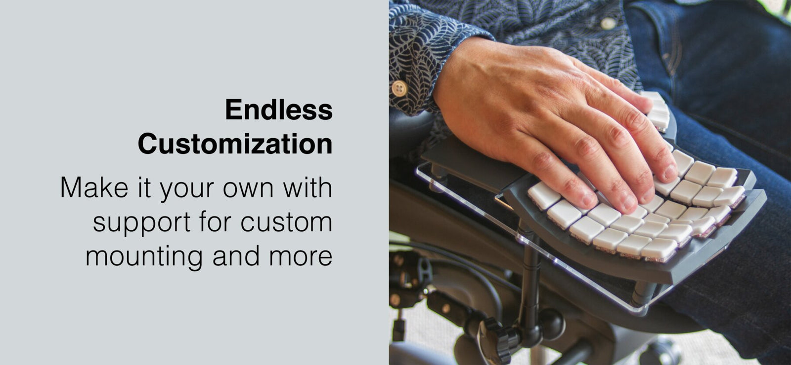 Close-up of chair mounted Glove80 ergonomic keyboard in use