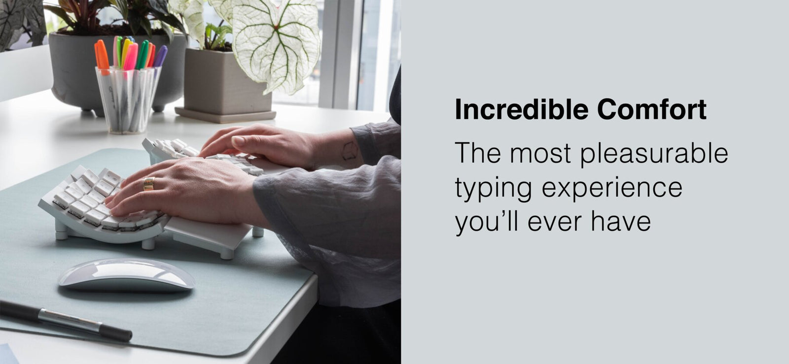 Person in office typing on Glove80 ergonomic keyboard using built-in wrist rests
